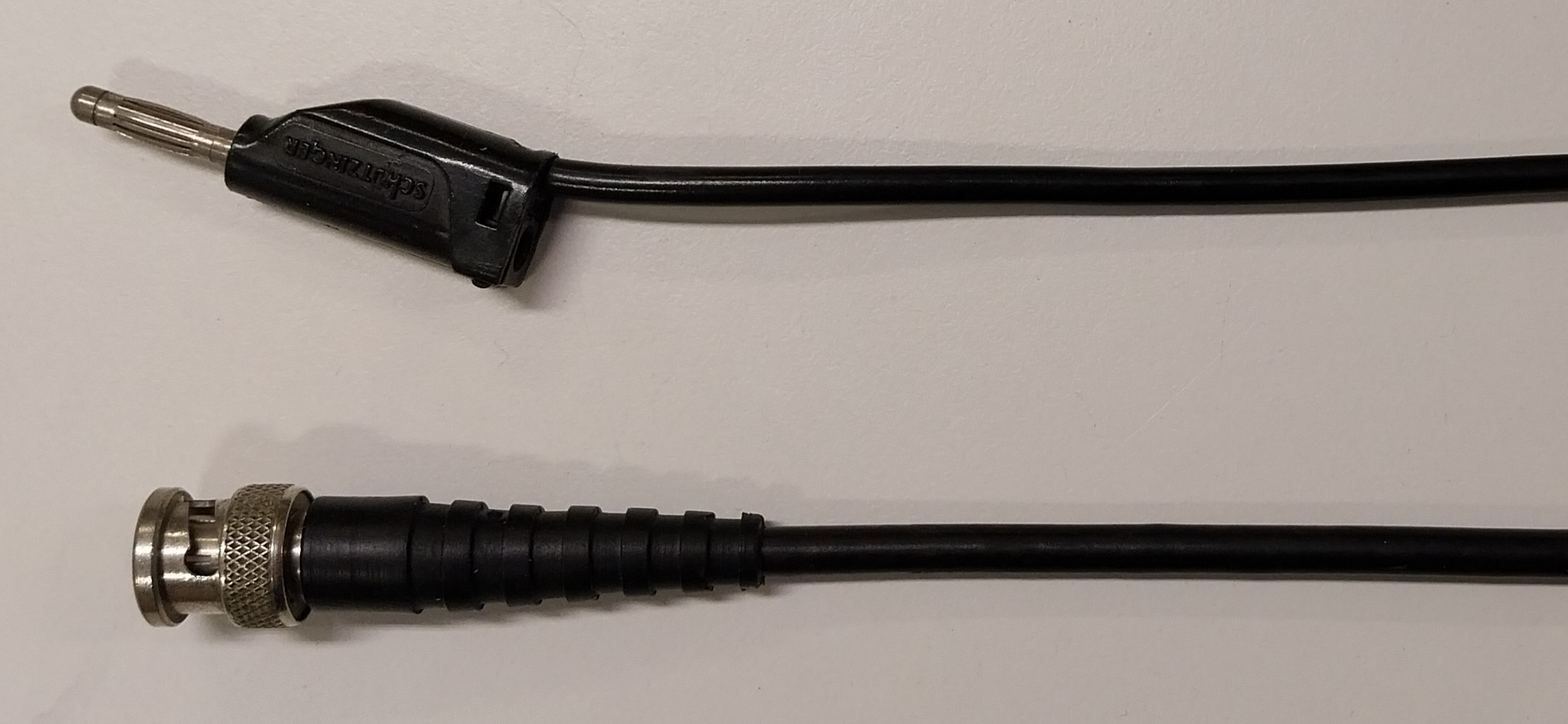 A reusable wire with a banana plug (top), and a coaxial cable with a female BNC connector (bottom).