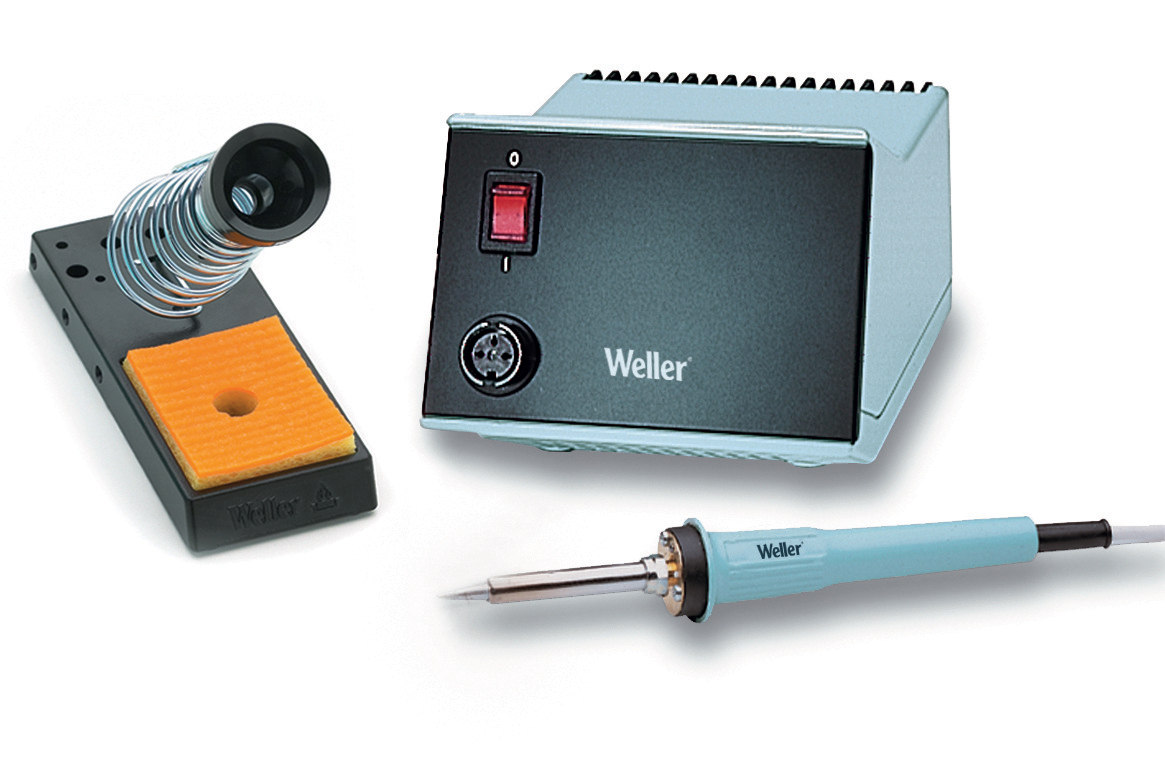 A soldering station with a holder and cleaning sponge.